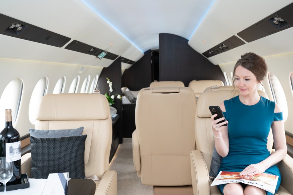 Woman relaxing in a luxury private jet cabin interior